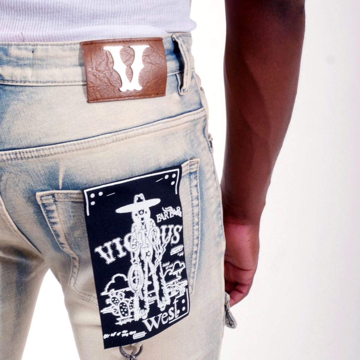 Flare fit denim pant w/ stone details + chains